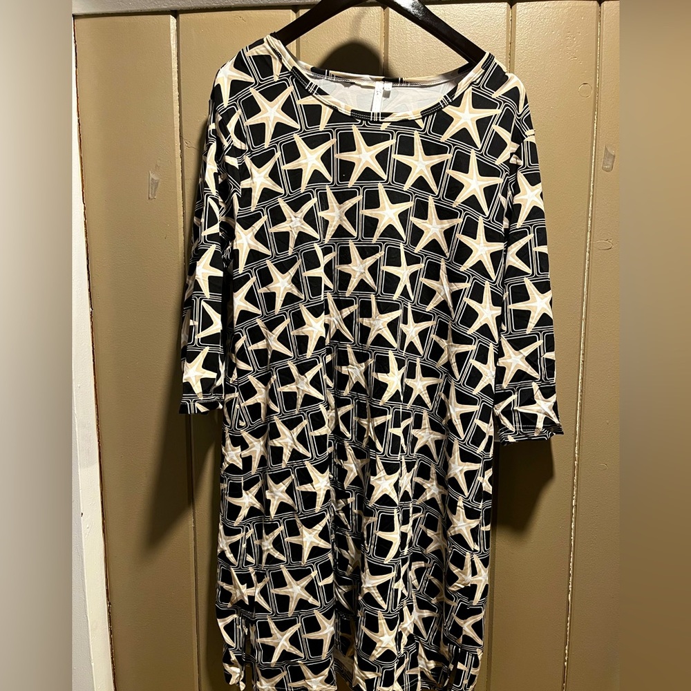 3/4 sleeve Black dress with starfish pattern. Mid length.